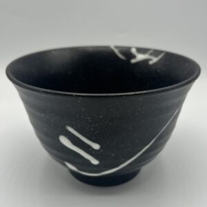 Black matcha bowl with white accents on outside